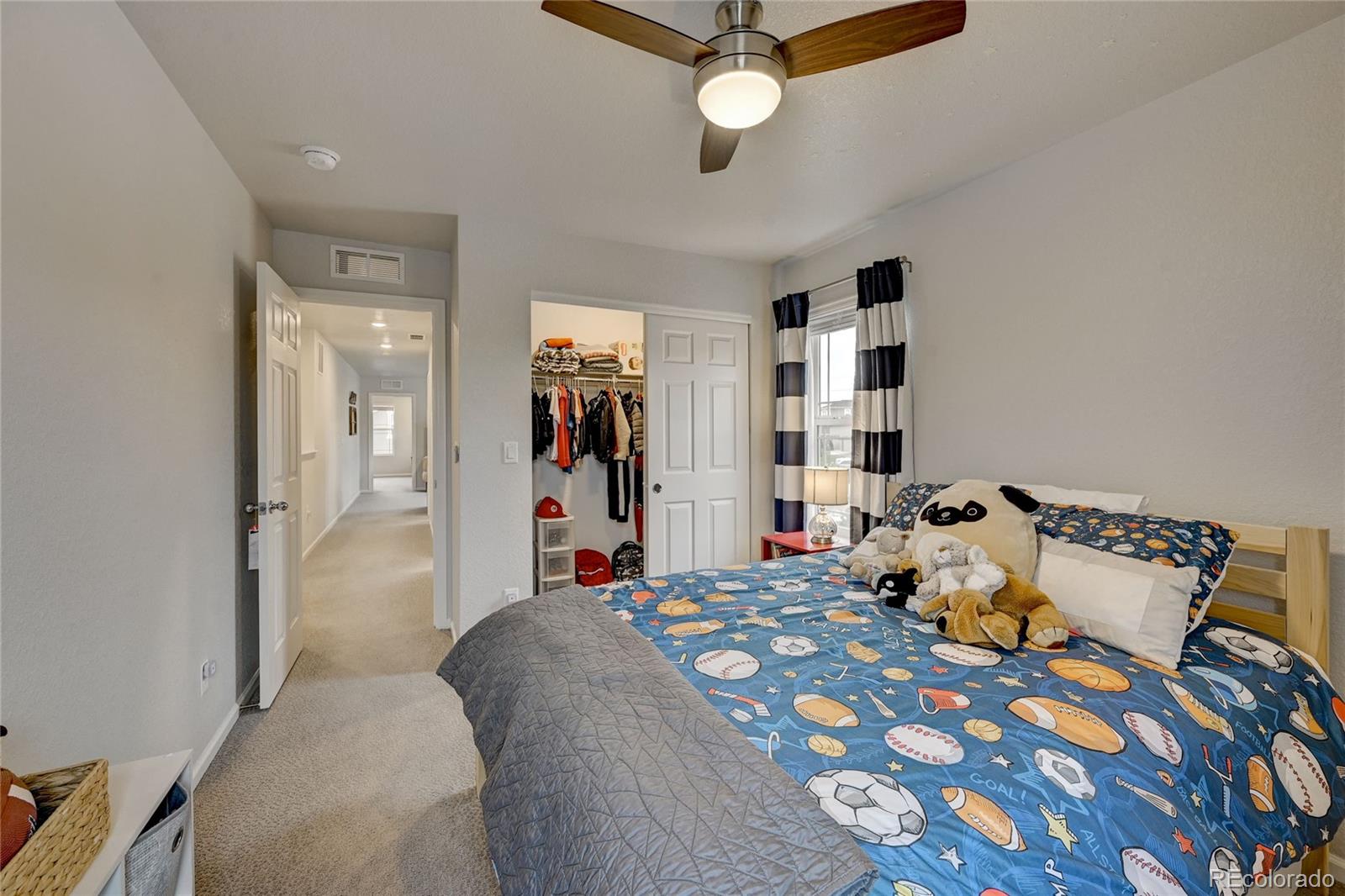 7203 Bedlam Drive Castle Pines, CO 80108 - Photo 27 of 39 a bed room with a bed and a chandelier