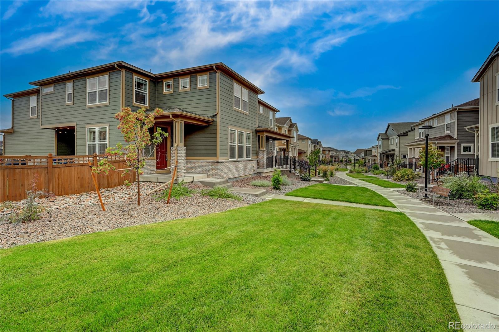 7203 Bedlam Drive Castle Pines, CO 80108 - Photo 3 of 39 a front view of a house with a yard