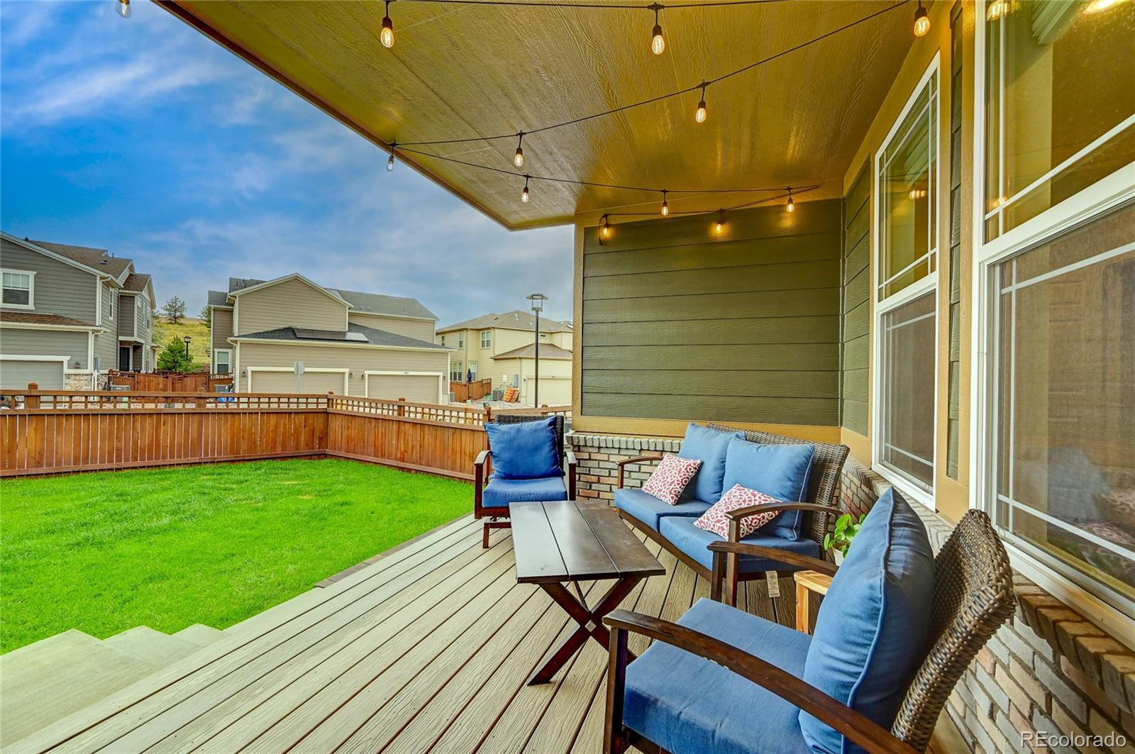 7203 Bedlam Drive Castle Pines, CO 80108 - Photo 32 of 39 a view of yard from deck with patio