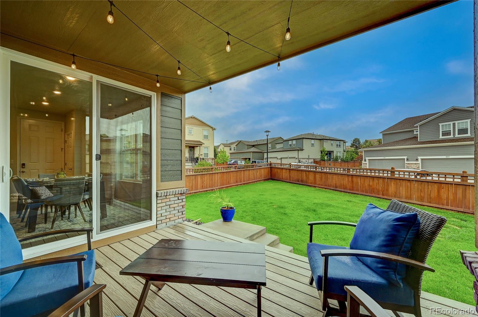 7203 Bedlam Drive Castle Pines, CO 80108 - Photo 33 of 39 a view of a patio with a table and chairs