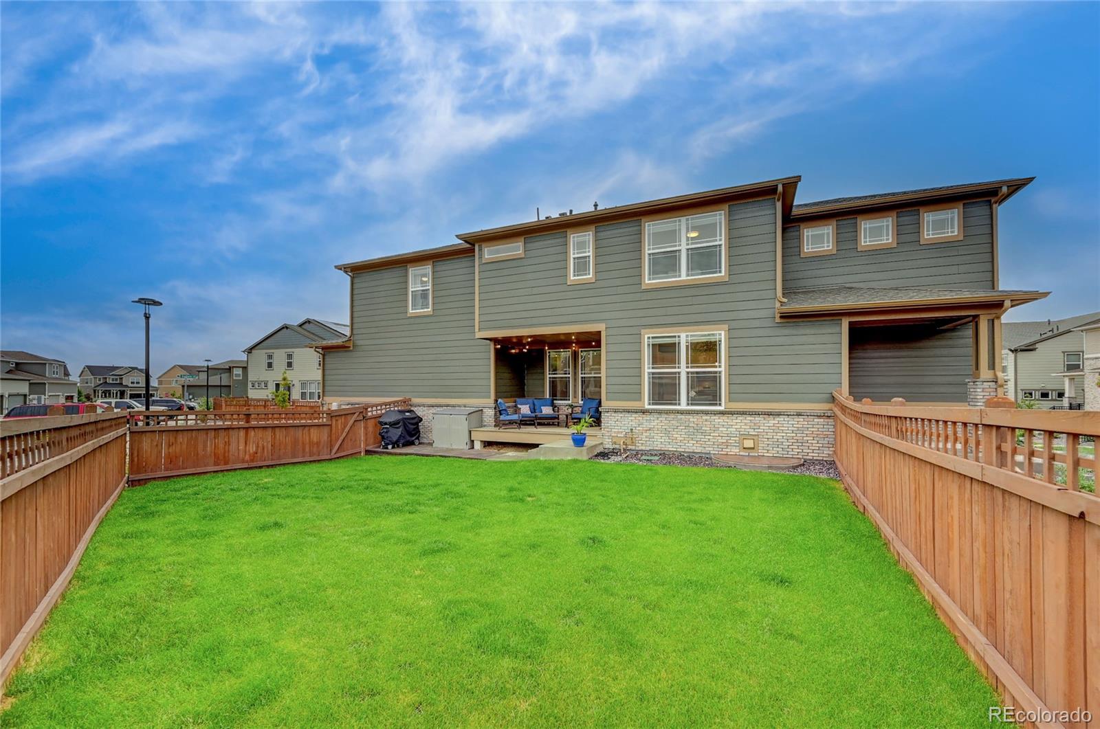 7203 Bedlam Drive Castle Pines, CO 80108 - Photo 34 of 39 a front view of house with yard and outdoor seating