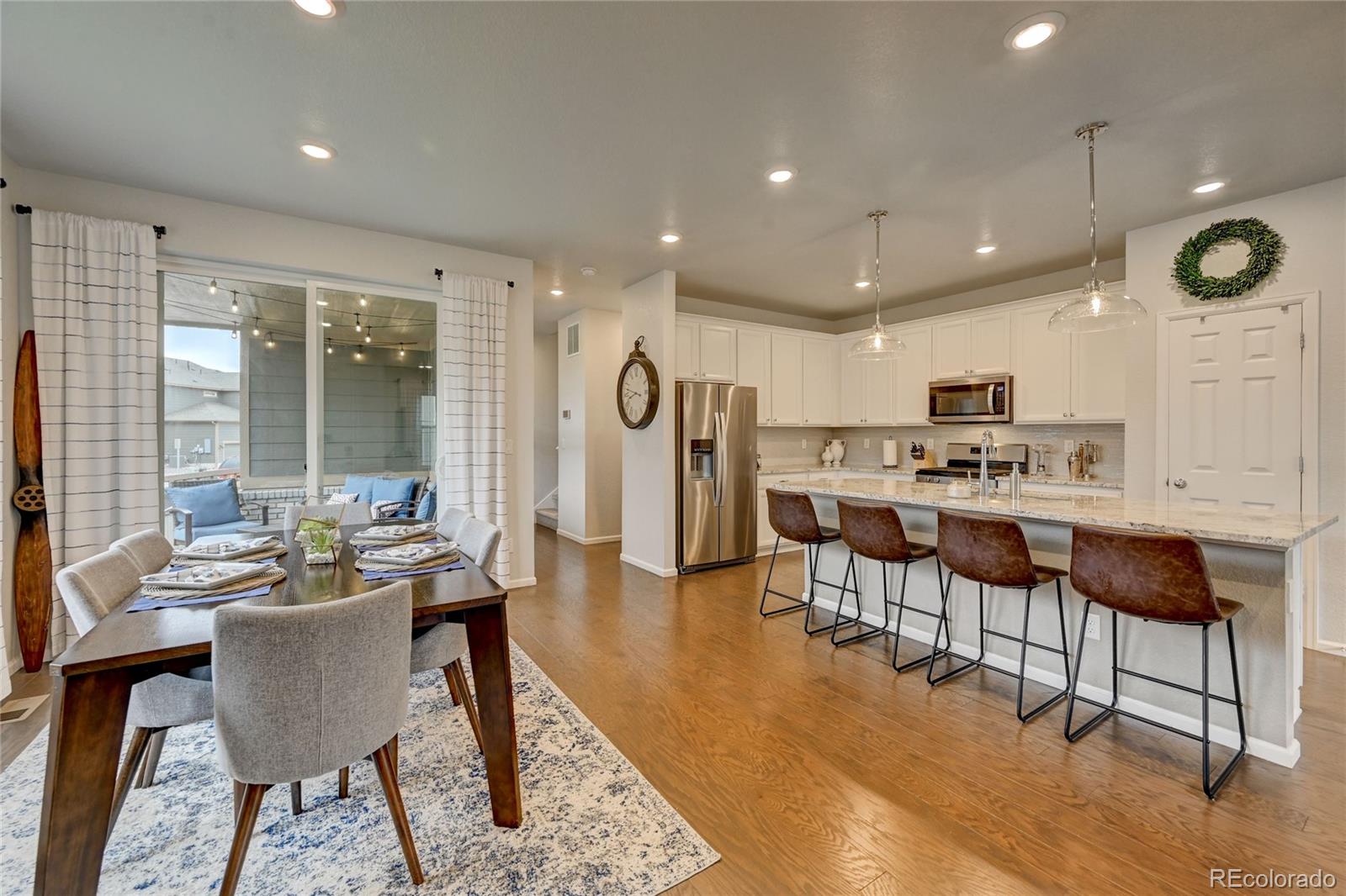 7203 Bedlam Drive Castle Pines, CO 80108 - Photo 5 of 39 a large kitchen with a table and chairs