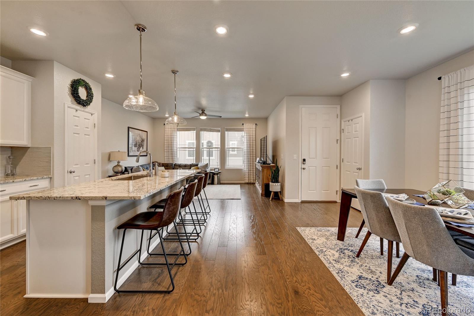 7203 Bedlam Drive Castle Pines, CO 80108 - Photo 6 of 39 a large kitchen with a table and chairs