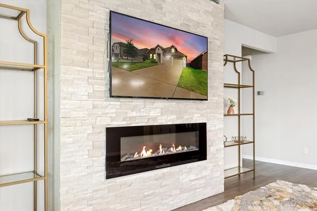 a living room with a fireplace and a flat screen tv