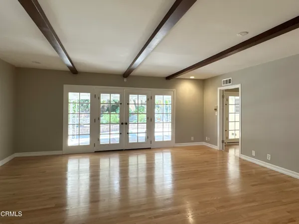 wooden floor in an empty room with a window