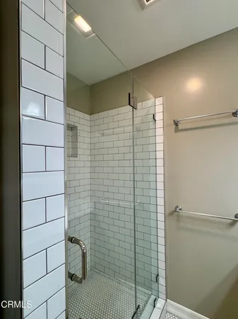 a bathroom with a sink a mirror and a light fixture