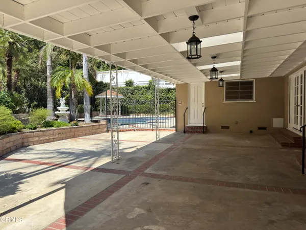 a swimming pool with barbeque oven outdoor seating and yard
