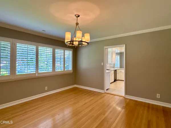 a kitchen with stainless steel appliances granite countertop a refrigerator a stove and white cabinets