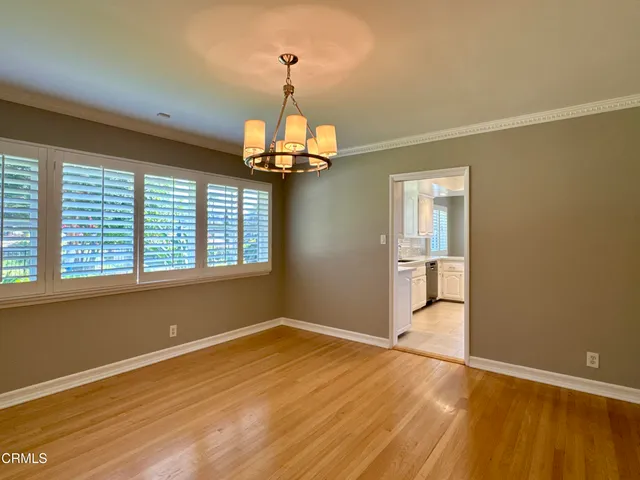 a kitchen with stainless steel appliances granite countertop a refrigerator a stove and white cabinets