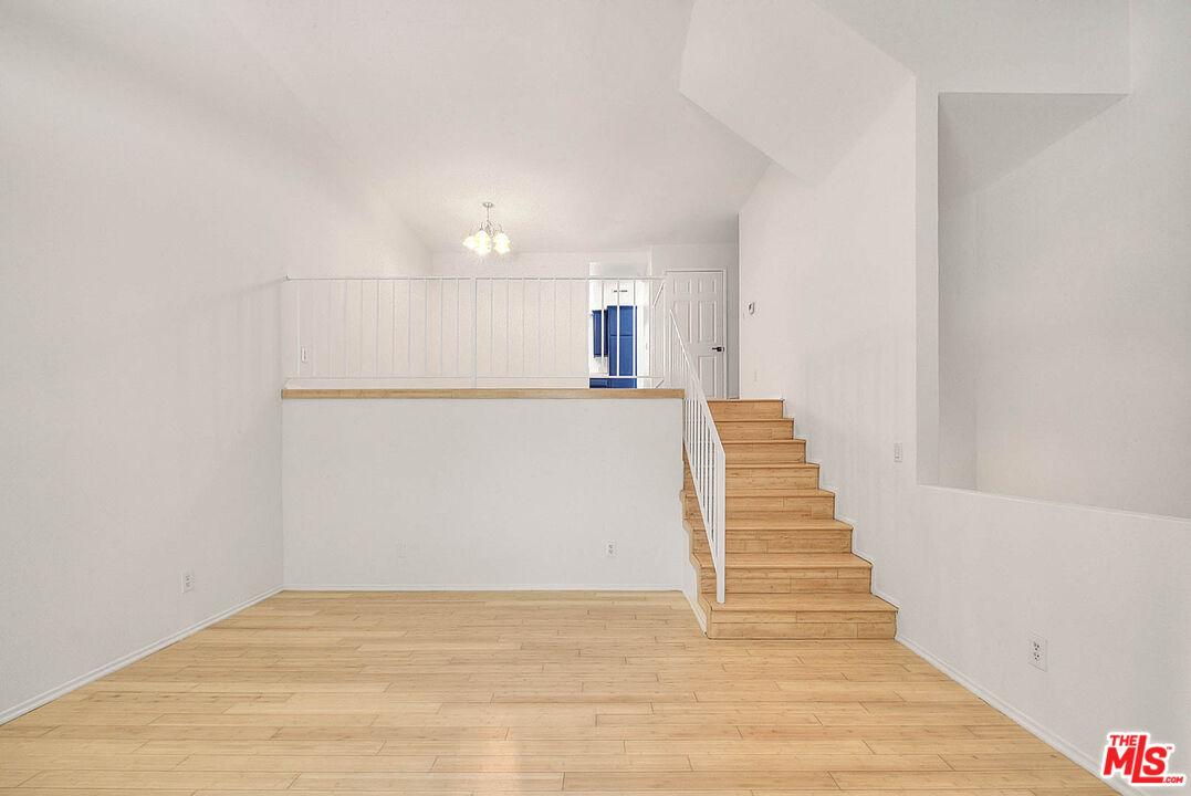 8741 Darby Avenue, Unit 16 Northridge, CA 91325 - Photo 11 of 43 a view of a hallway with wooden floor and staircase