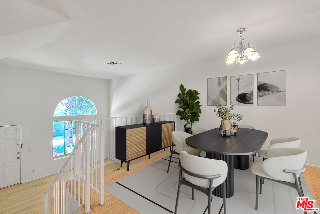 8741 Darby Avenue, Unit 16 Northridge, CA 91325 - Photo 13 of 43 a dining room with furniture a chandelier and wooden floor