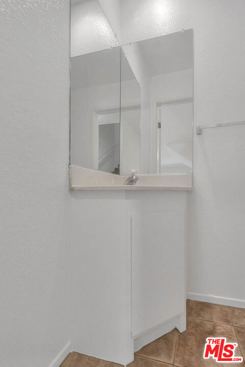 8741 Darby Avenue, Unit 16 Northridge, CA 91325 - Photo 18 of 43 a bathroom with a sink and mirror