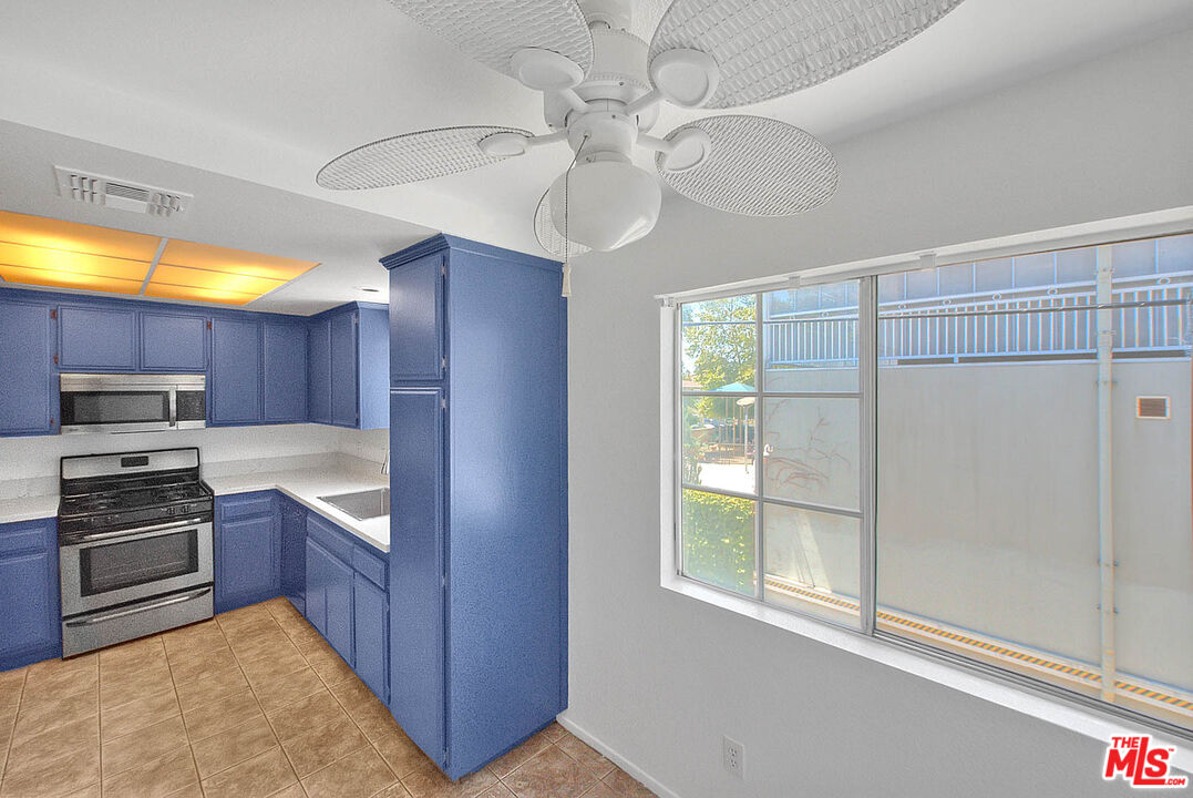 8741 Darby Avenue, Unit 16 Northridge, CA 91325 - Photo 22 of 43 a kitchen with stainless steel appliances granite countertop a refrigerator and a sink