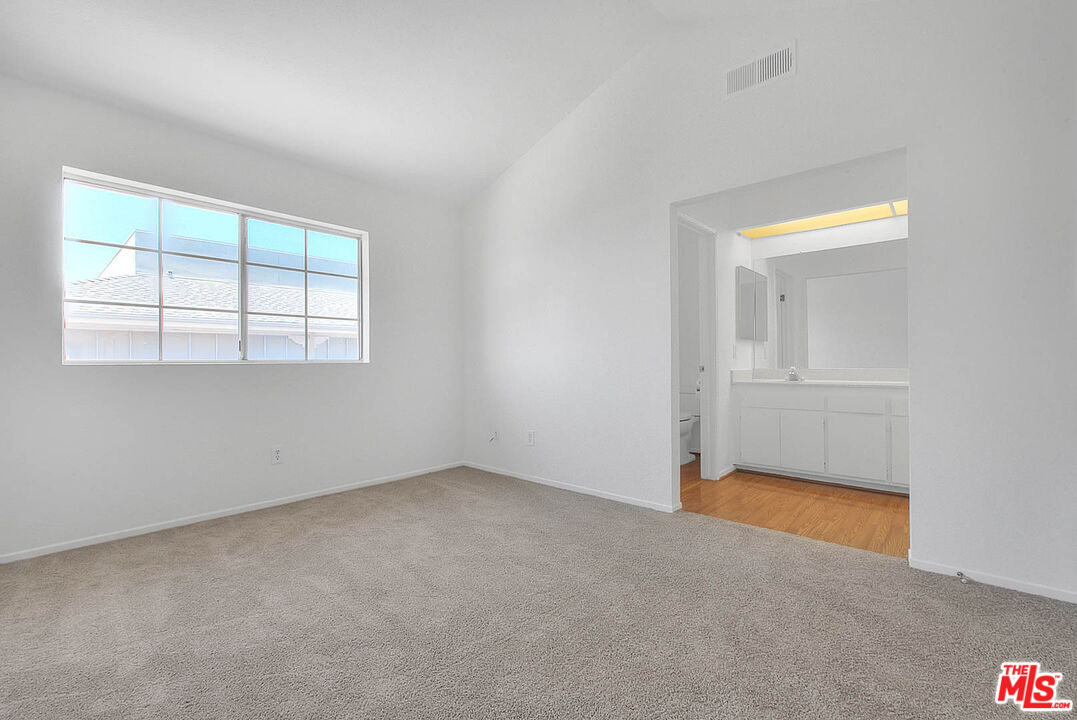 8741 Darby Avenue, Unit 16 Northridge, CA 91325 - Photo 24 of 43 an empty room with windows