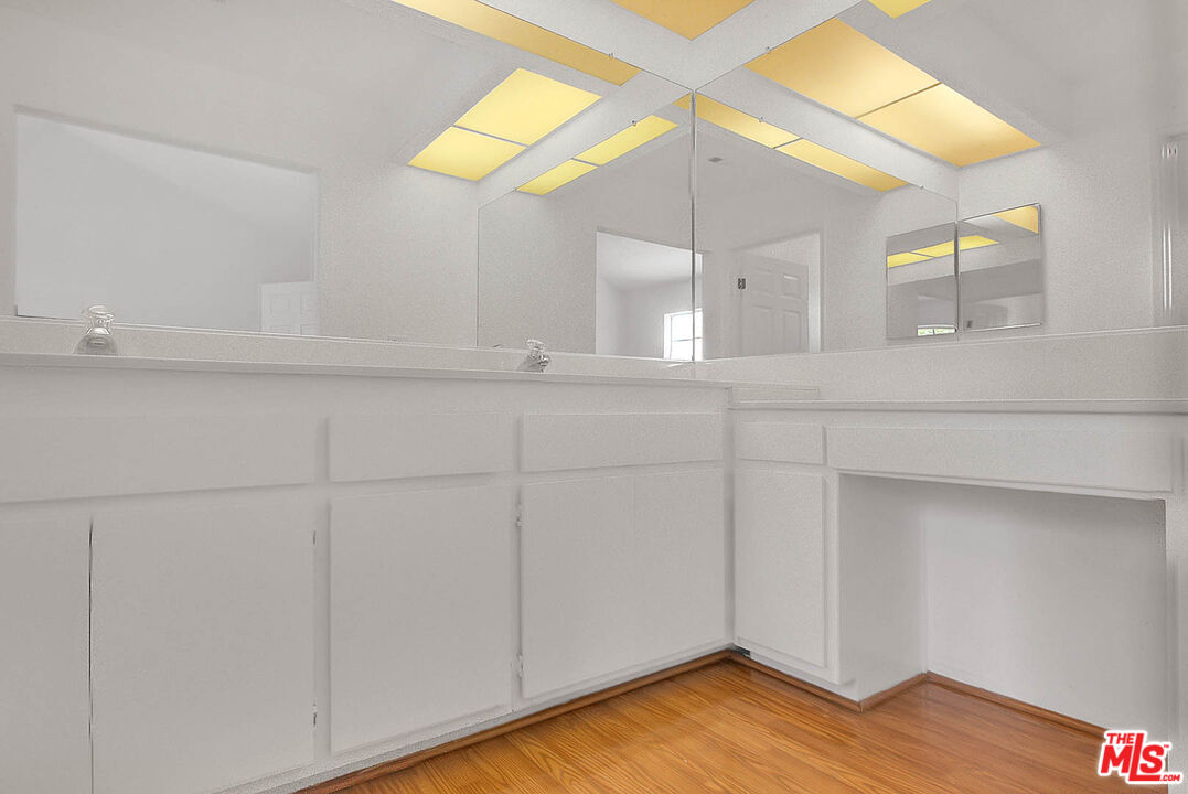 8741 Darby Avenue, Unit 16 Northridge, CA 91325 - Photo 27 of 43 a view of a storage & utility room with wooden floor