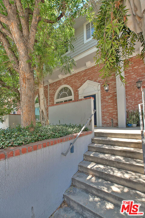 8741 Darby Avenue, Unit 16 Northridge, CA 91325 - Photo 3 of 43 a front view of a house with garden
