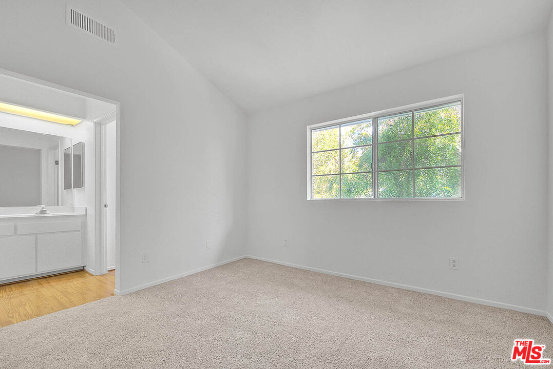 8741 Darby Avenue, Unit 16 Northridge, CA 91325 - Photo 34 of 43 an empty room with a window