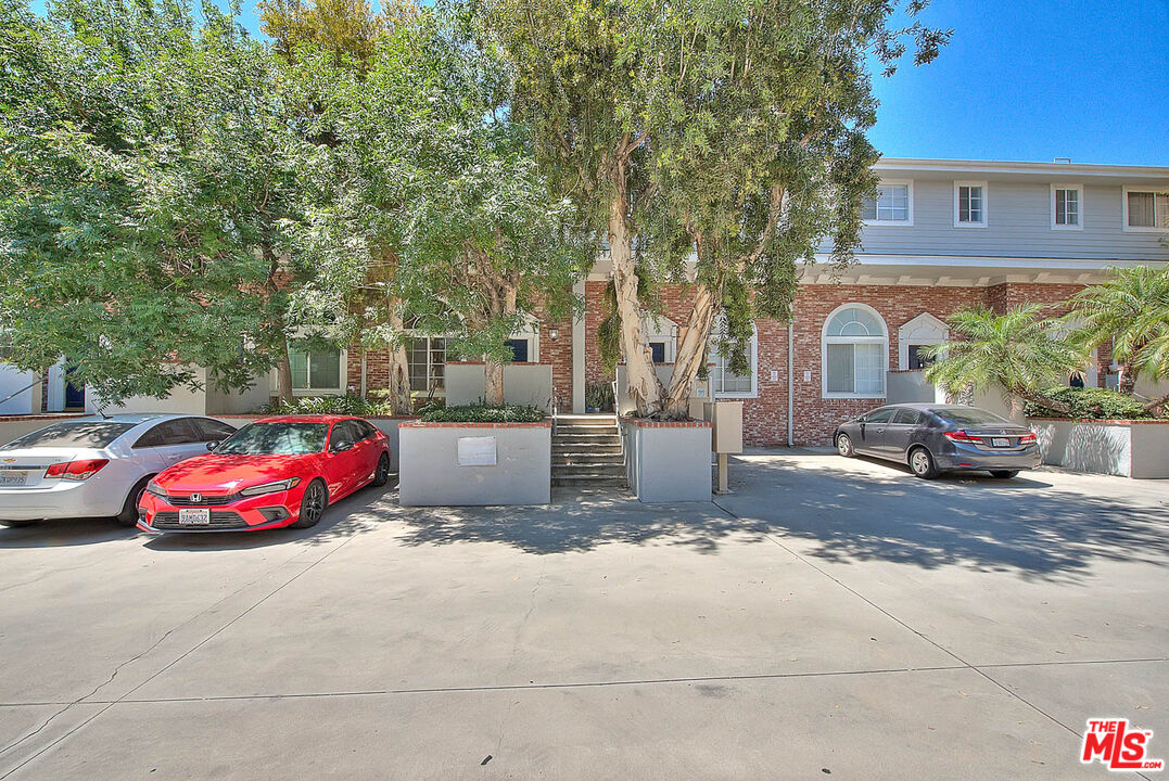 8741 Darby Avenue, Unit 16 Northridge, CA 91325 - Photo 41 of 43 a front view of a house with large garden and outdoor seating