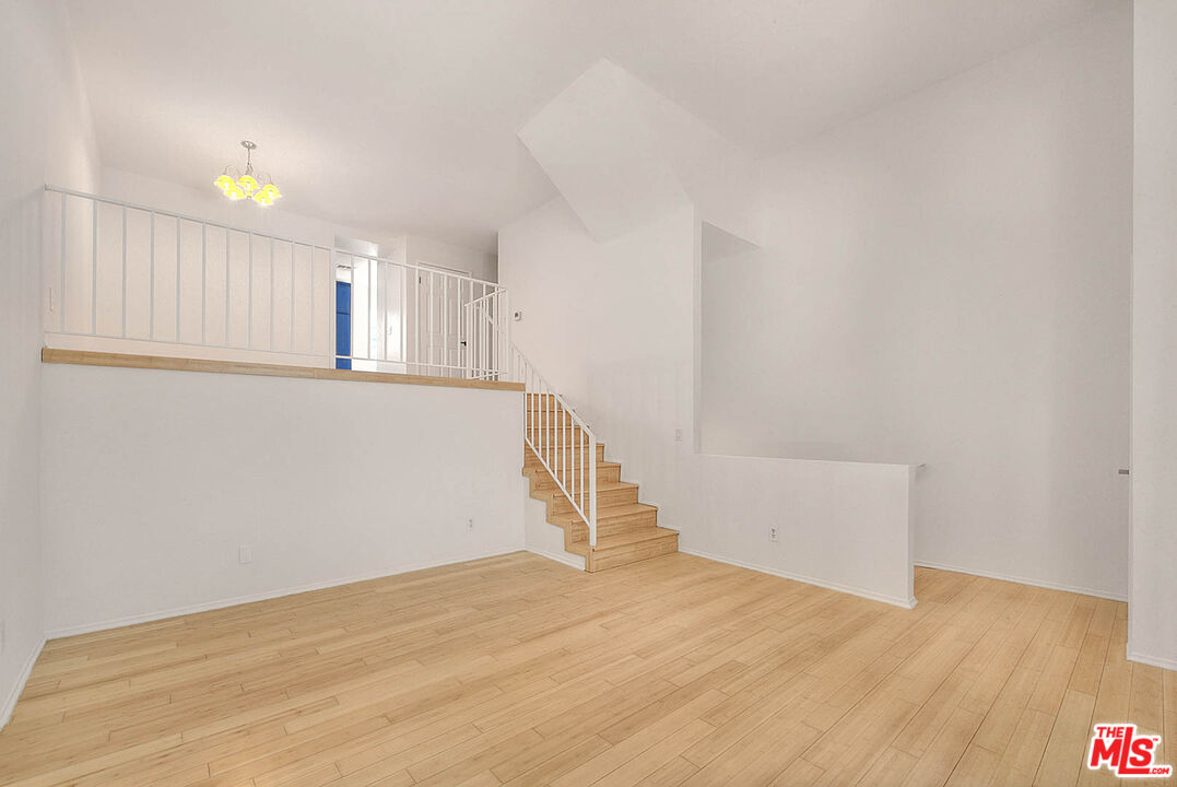 8741 Darby Avenue, Unit 16 Northridge, CA 91325 - Photo 8 of 43 a view of empty room with wooden floor