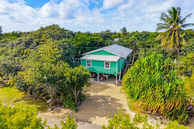 a living room with furniture kitchen view and a large window