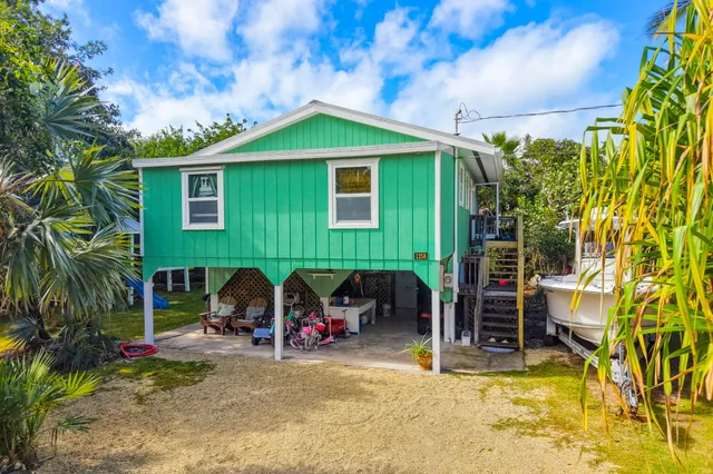 a living room with furniture kitchen view and a large window