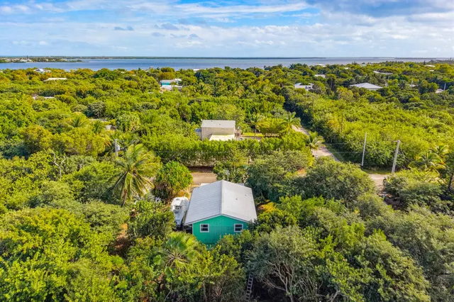 a living room with furniture and a dining table with kitchen view