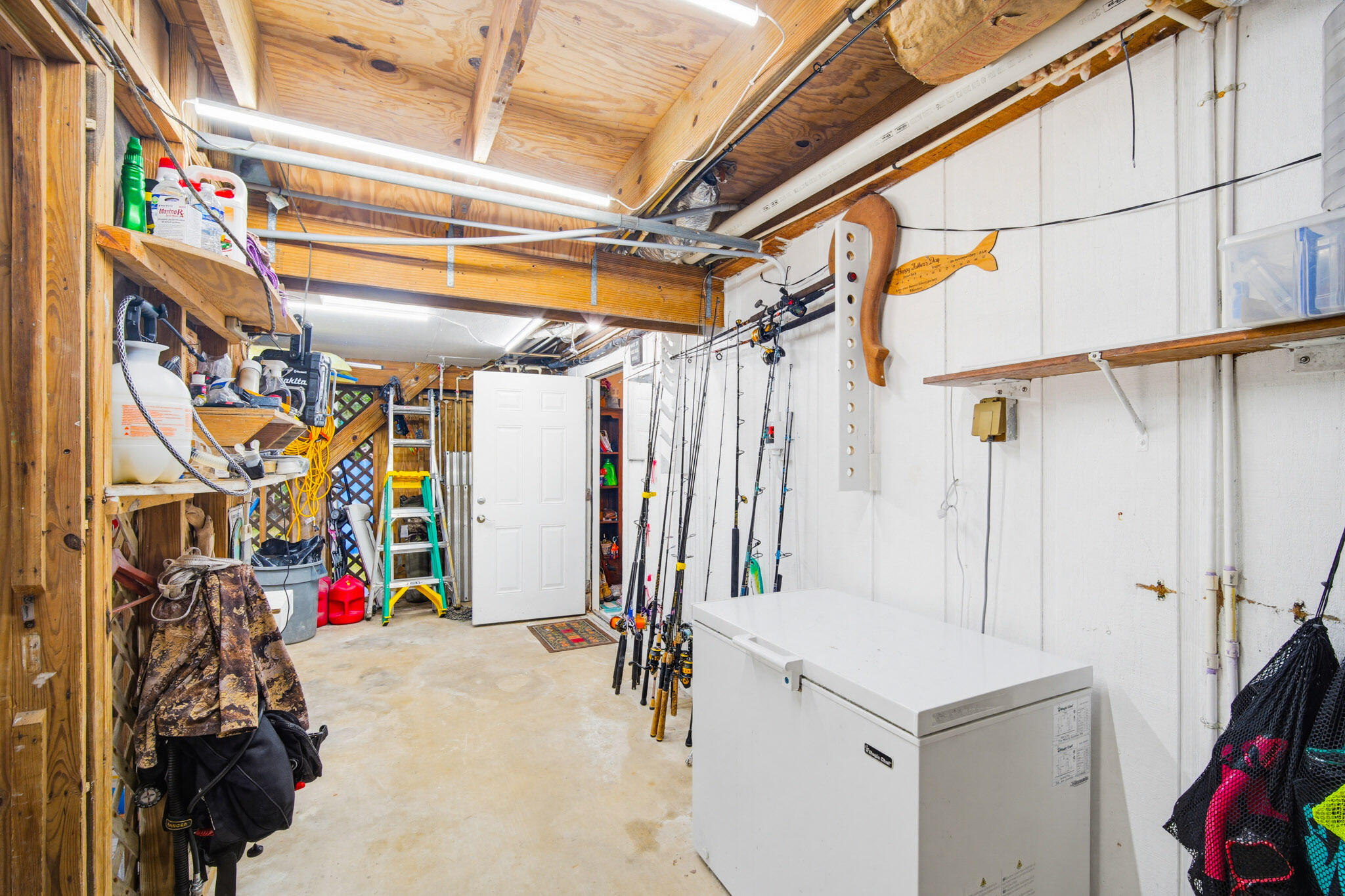 1258 Division Street Big Pine Key, FL 33043 - Photo 26 of 79 a view of walk in closet with clothes