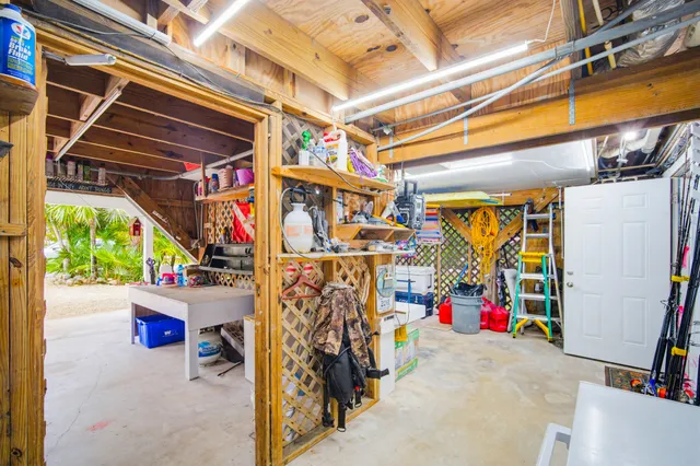 a kitchen with a dining table chairs and white appliances