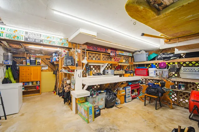 a open kitchen with stainless steel appliances granite countertop a refrigerator a stove and a refrigerator with wooden floor