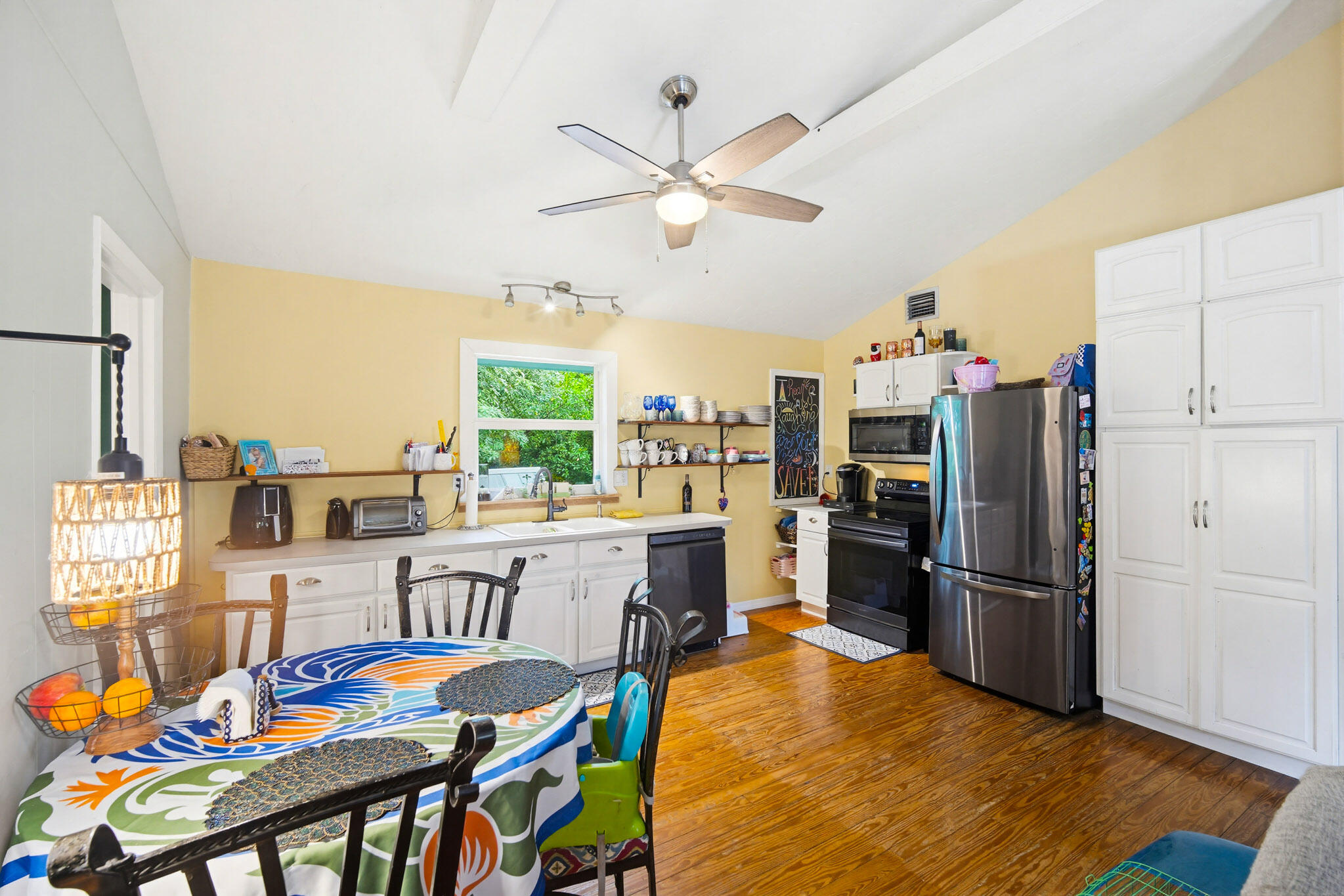 1258 Division Street Big Pine Key, FL 33043 - Photo 35 of 71 a kitchen with stainless steel appliances granite countertop a dining table chairs refrigerator and sink