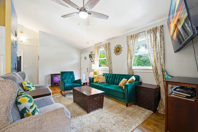 a view of a kitchen with a stove wooden floor cabinet and mirror