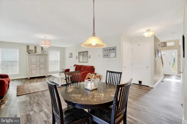 a dining room with furniture and wooden floor