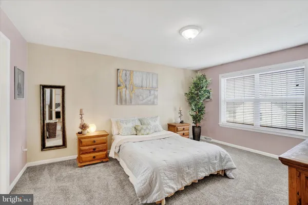 a bedroom with a bed and a potted plant