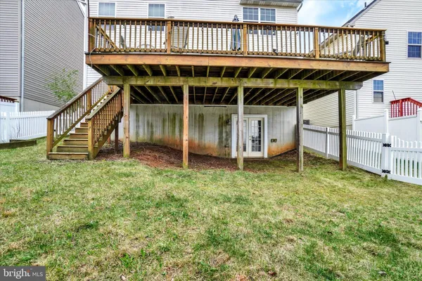 a view of a house with wooden deck and a garden