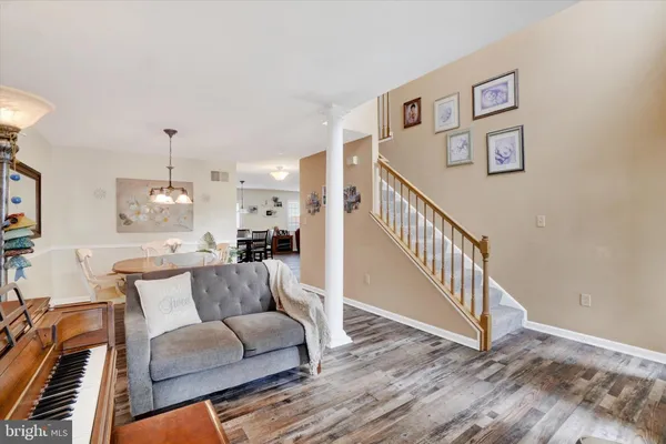 a living room with furniture and wooden floor