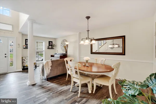 a dining room with furniture and wooden floor