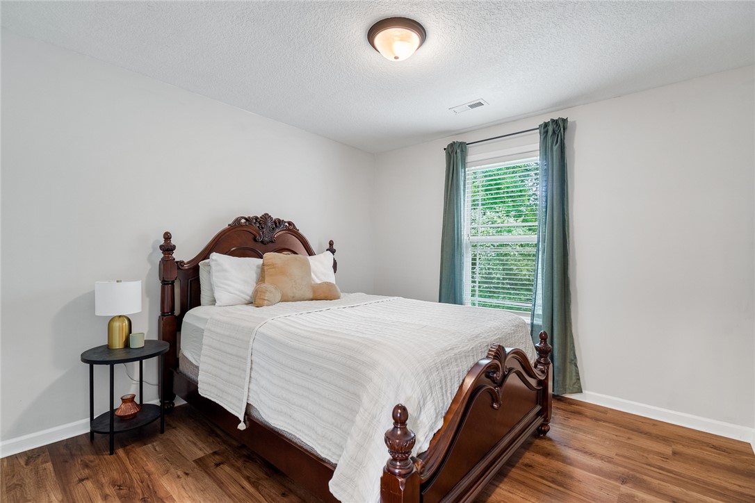 108 Belspring Lane Anderson, SC 29621 - Photo 14 of 19 This serene bedroom offers a tranquil retreat with warm flooring and ample natural light.