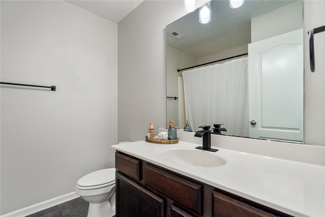108 Belspring Lane Anderson, SC 29621 - Photo 16 of 19 This clean and inviting bathroom features a single vanity with ample counter space and a modern toilet.