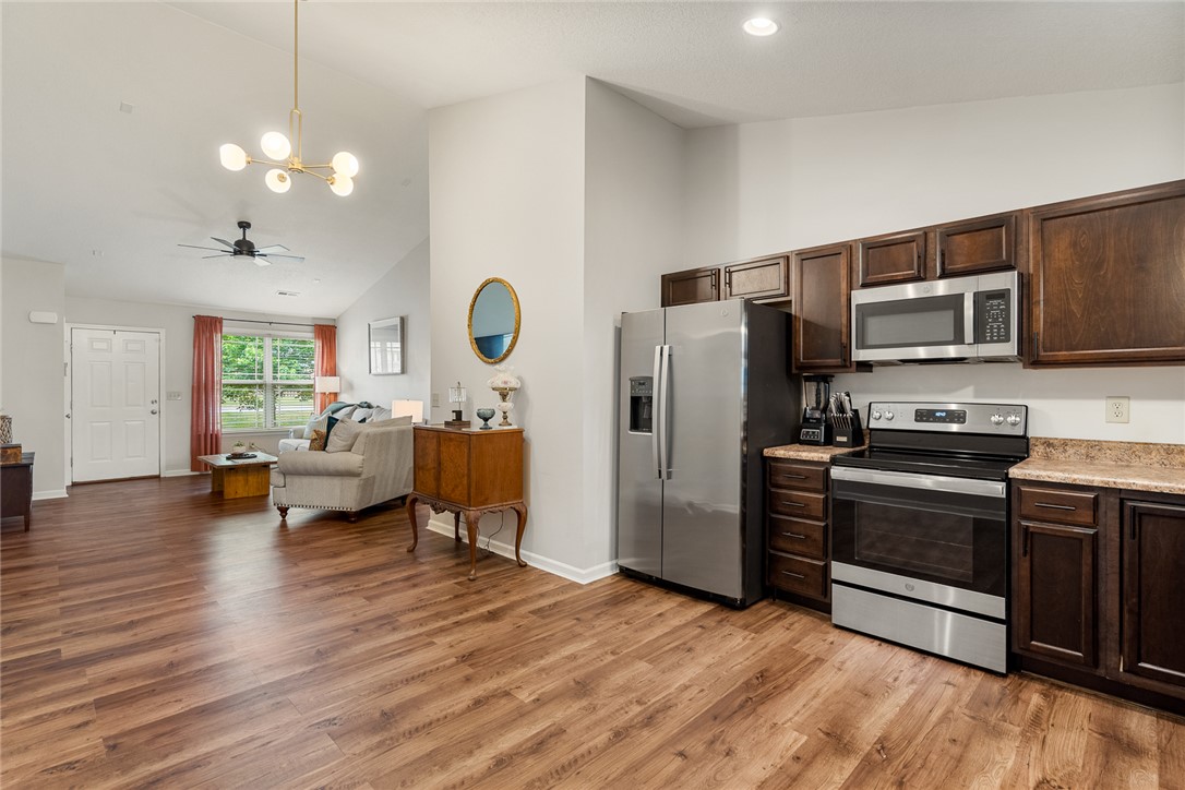 108 Belspring Lane Anderson, SC 29621 - Photo 6 of 19 This open concept living space seamlessly blends kitchen and living areas with beautiful wood flooring.