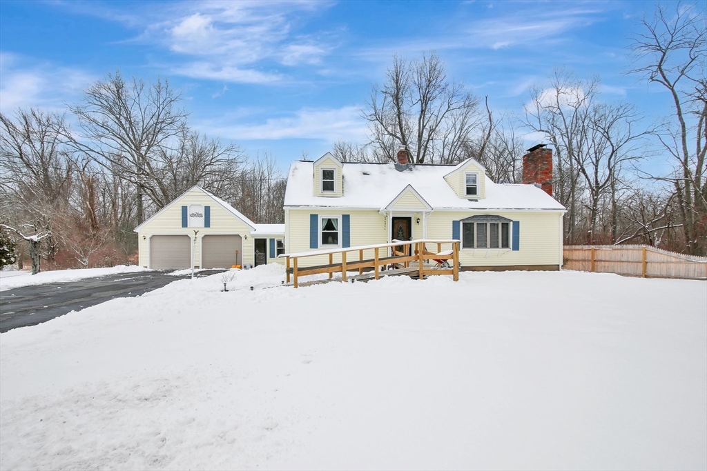 a front view of a house with yard and mountain view