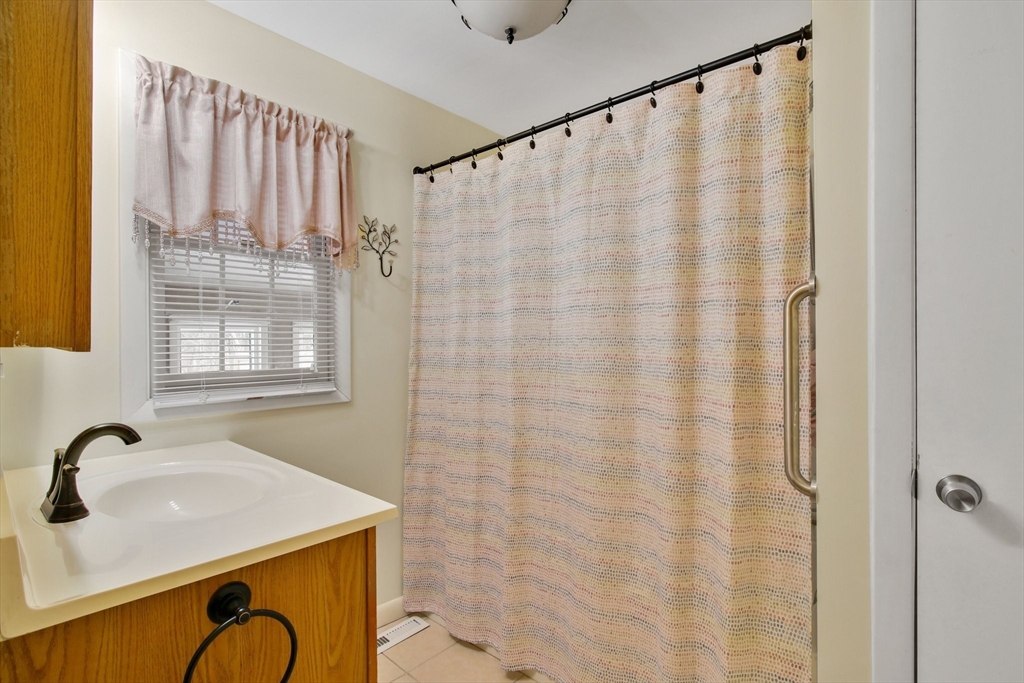 1038 Morgan Road West Springfield, MA 01089 - Photo 16 of 31 a bathroom with a granite countertop sink and a mirror