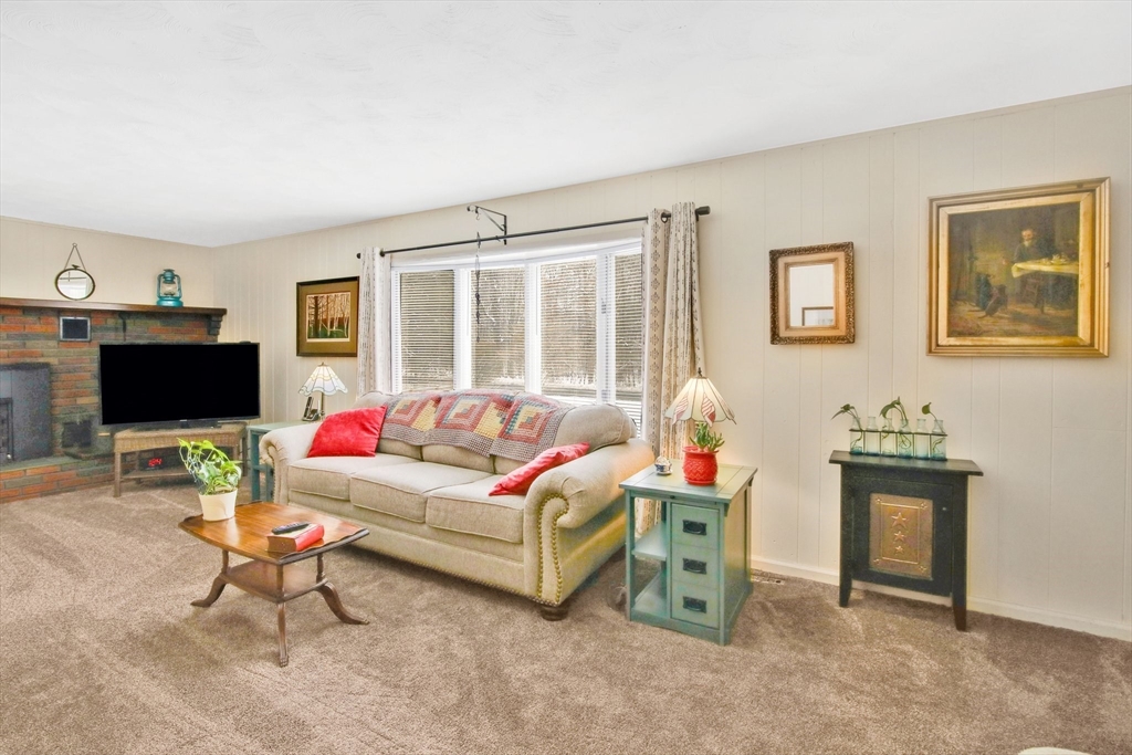 1038 Morgan Road West Springfield, MA 01089 - Photo 6 of 31 a living room with furniture a flat screen tv and a floor to ceiling window