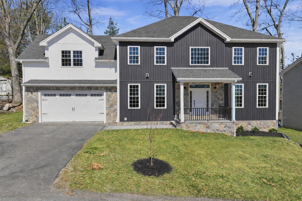a front view of a house with a yard and garage