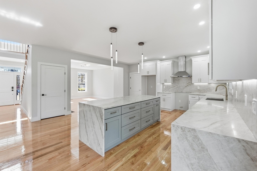 6 Barrows Road Worcester, MA 01609 - Photo 4 of 41 a large kitchen with stainless steel appliances kitchen island granite countertop a large counter top a sink and a wooden floors