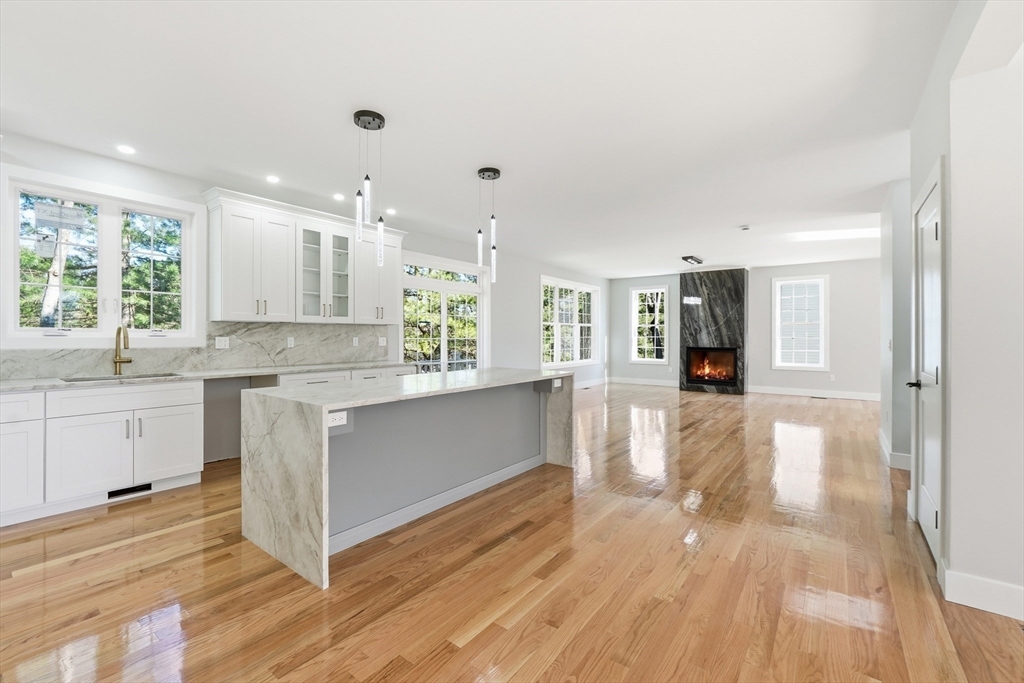 6 Barrows Road Worcester, MA 01609 - Photo 7 of 41 a large white kitchen with a refrigerator a sink dishwasher a stove and white cabinets with wooden floor