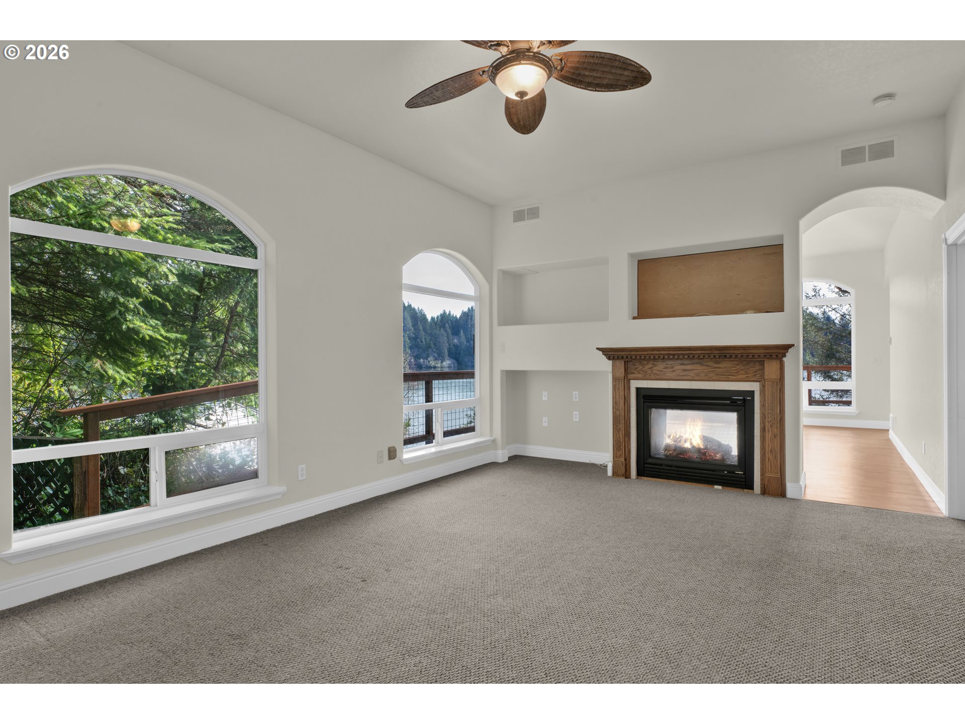 5816 Martin Road Florence, OR 97439 - Photo 26 of 47 a view of an empty room with a fireplace and a window