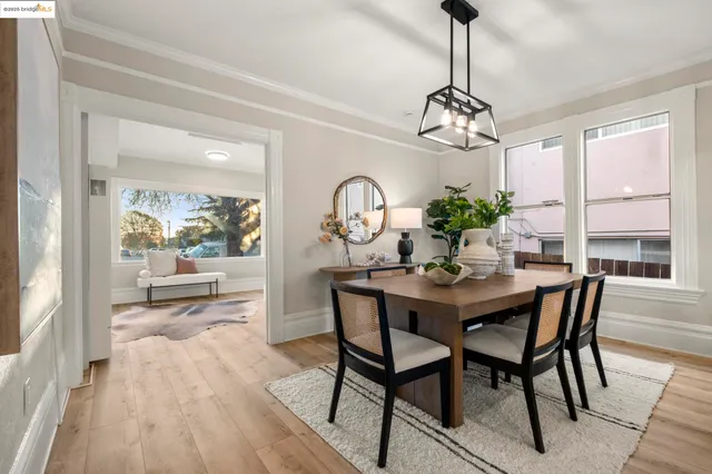 a view of a dining room with furniture wooden floor and a chandelier
