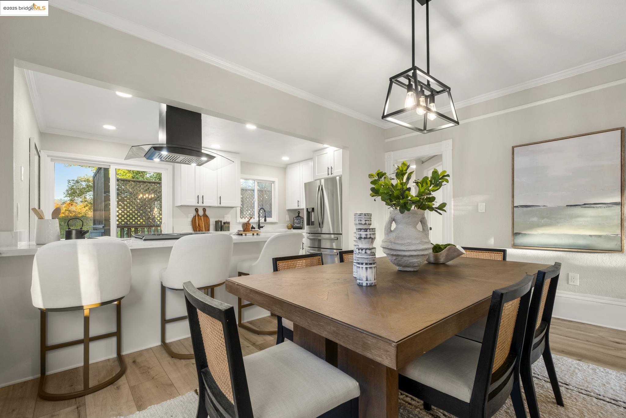2050 East 30th Street Oakland, CA 94606 - Photo 12 of 48 Dining area with light wood-style floors, crown molding, and recessed lighting
