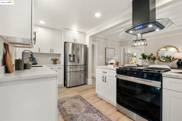 a kitchen with refrigerator a stove and a sink