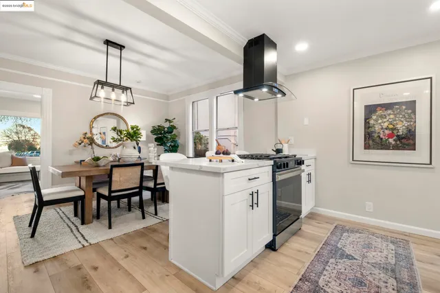 a very nice looking dining room with a table chairs and a chandelier